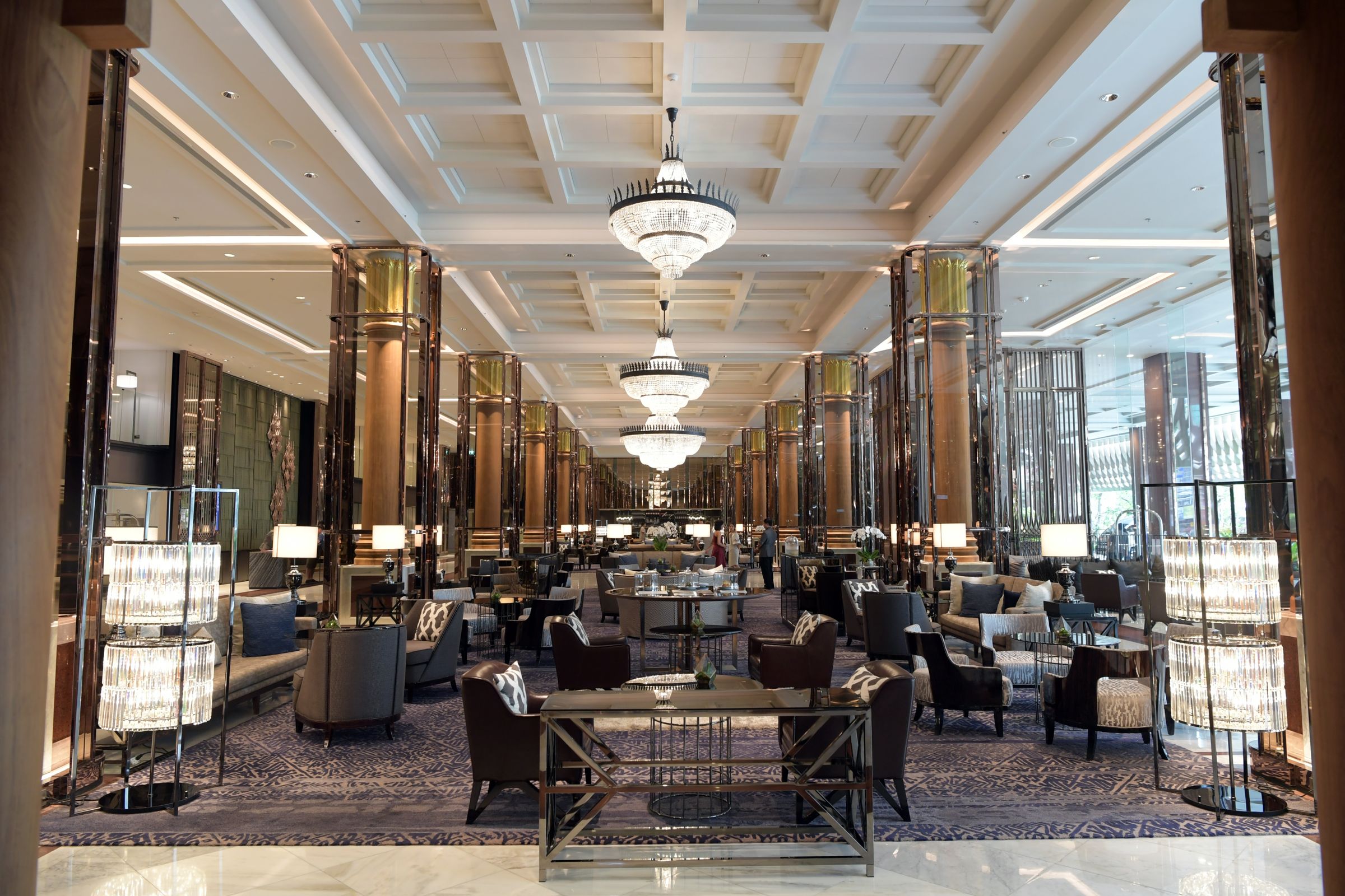 Spacious, sophisticated hotel lobby with warm lighting