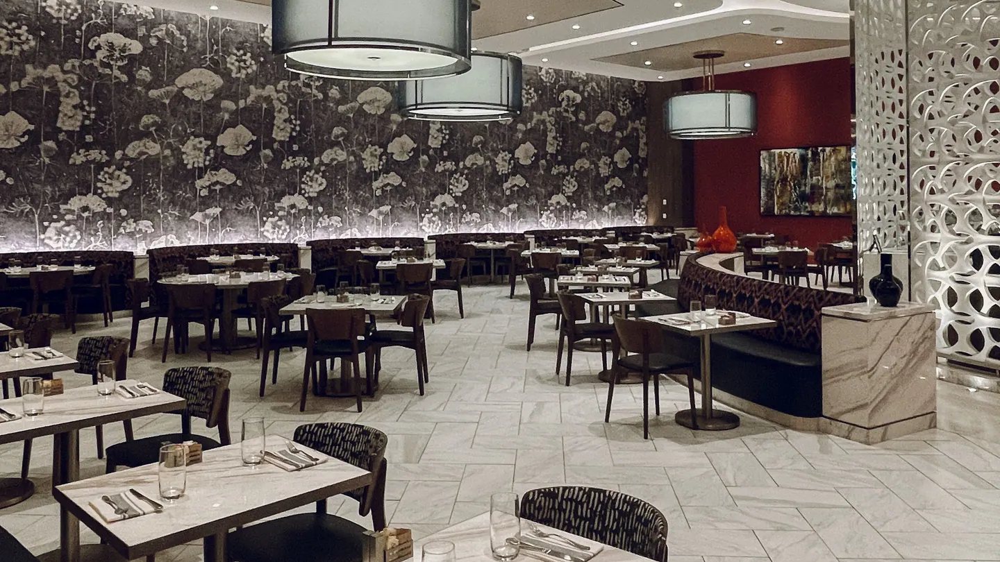 Restaurant dining room with hard surfaces and occupied tables, illustrating the sound resultant of the space